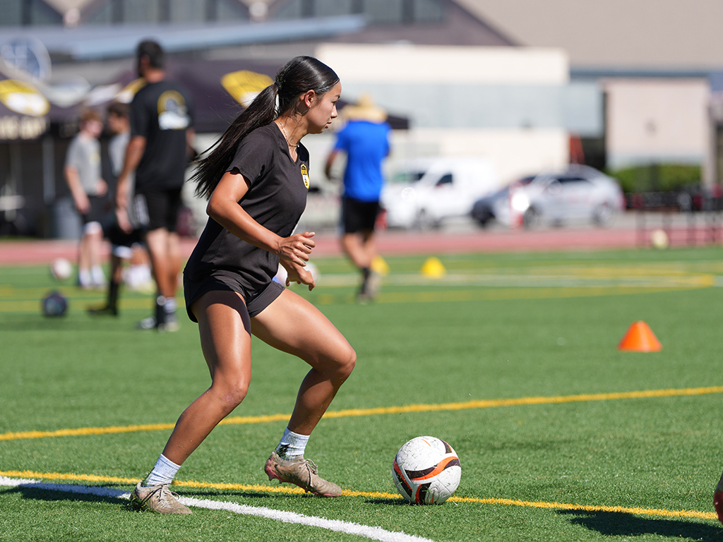 A player dribbling the ball during an LGU summer development session in 2026.