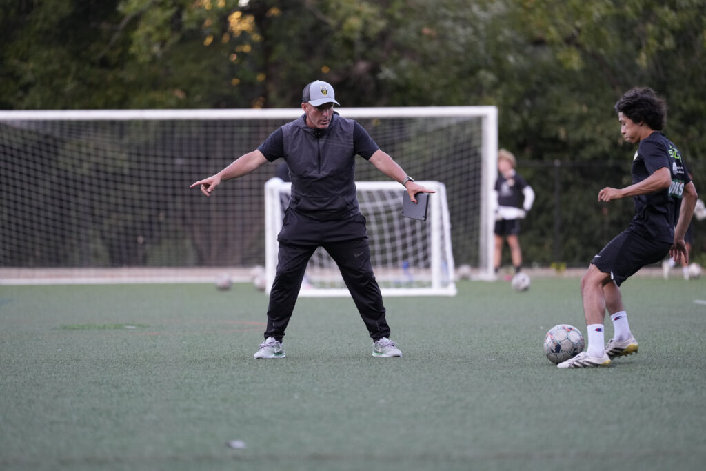 Los Gatos United coach instructing a player during training