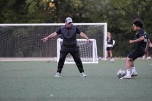 Los Gatos United coach instructing a player during training