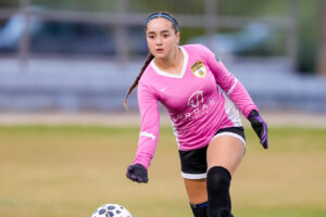 Los Gatos United girls' soccer goalkeeper in pink jersey during a competitive match