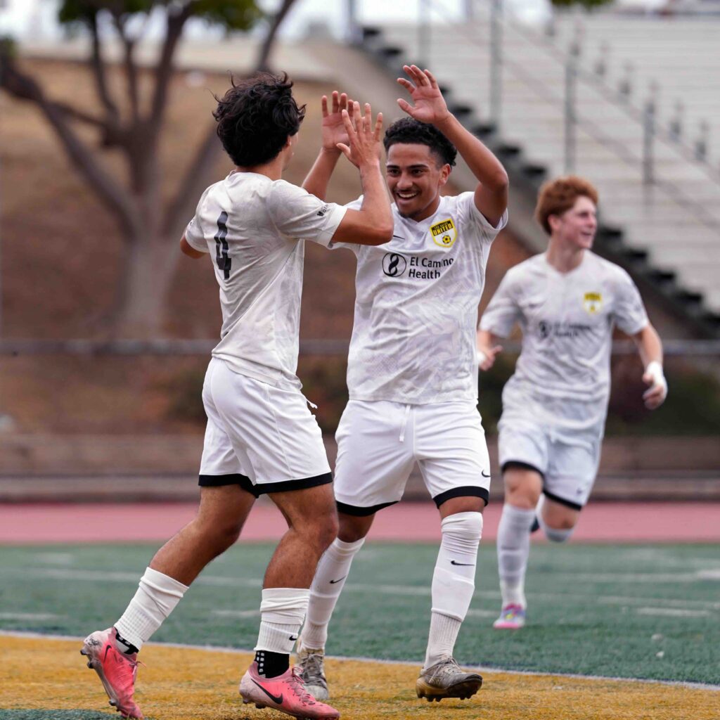 Los Gatos United U19 boys soccer players celebrating with a high five
