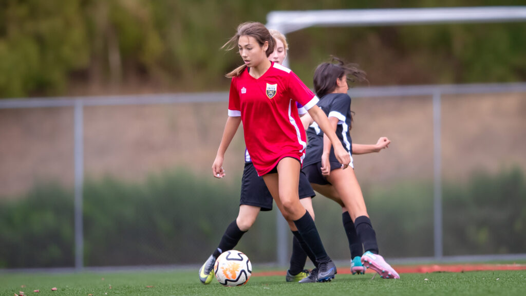 Los Gatos United teen soccer player dribbling during a Super Rec match