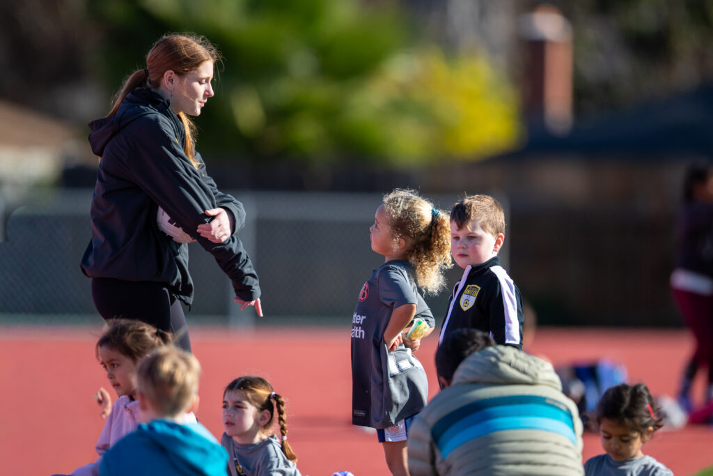 Los Gatos United coach talking with young players during December Break Camp
