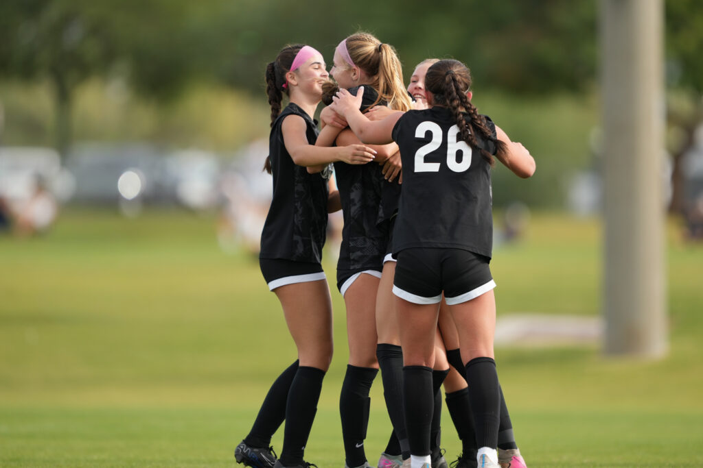 Los Gatos United girls competitive players celebrating together on the field